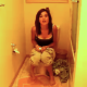 A brief video clip of a brunette girl pooping on a toilet and in need of wiping her ass.